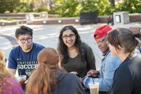 Mita Sudhakar talking to a small group of friends