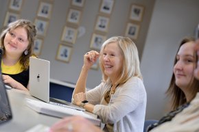 Susan McArver, center, sits with students while teaching a class