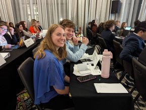 Anna Vielman and other delegates sit at a conference table at SRMUN