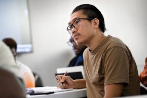 Lai Hnin takes notes in a class session