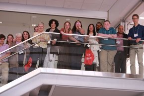 Students and faculty wave from balcony at NCAS meeting