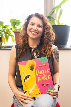 Carly York displays the cover of her book Queens of the Jungle