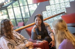 Three older students in conversation at Joe's Coffee