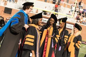 Kerry Thompson places academic hoods on DNP graduates at 2024 commencement