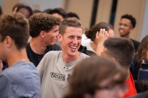 Isaac Riggs laughs with friends in the midst of a crowd at Final Flip