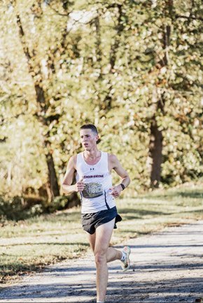 Isaac Riggs running on a cross-country trail