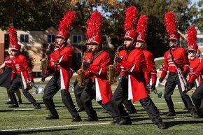 Saxophone players in the marching band slide to the left during a performance on Moretz field