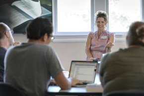 A professor speaks in front of a class