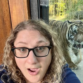 Kat Heiden in front of a tiger enclosure