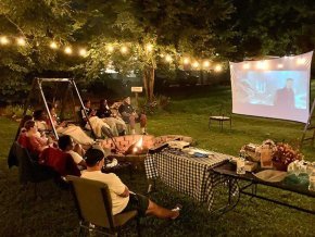 International students enjoying a cookout and movie under the stars.