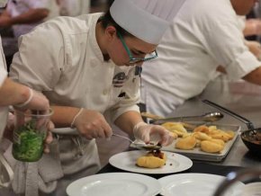 A culinary student prepares a meal.