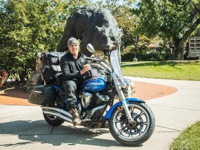 Bobby Jackson sits on his motorcycle in front of the Charge on campus.