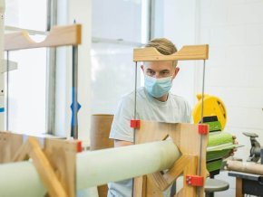 An LR student works on building a rocket