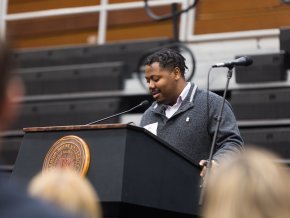 Cardo Grant stands at a podium inside