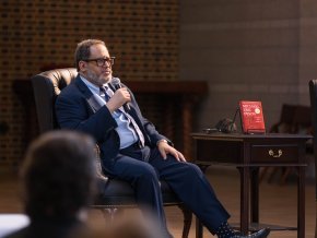 Michael Eric Dyson sits in a chair on a stage