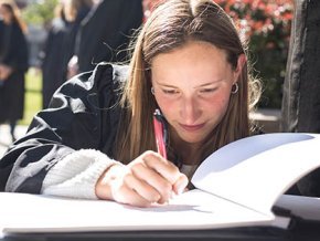 Lisa Boernigen signs the graduation book