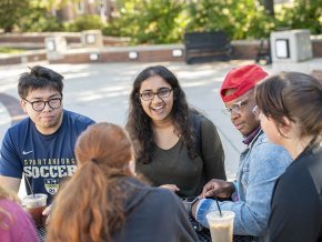 Mita Sudhakar talking to a small group of friends