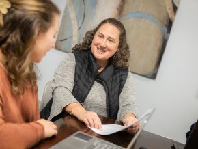 Alyssa Stewart, right, sits with a student