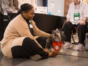 A staff member bonds with a therapy dog in Cromer Center