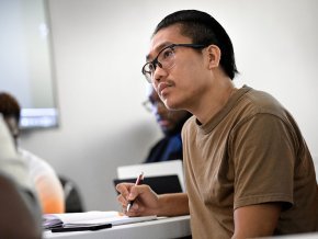 Lai Hnin takes notes in a class session