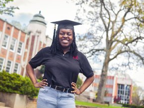 Kiera Elliott standing in front of the Rhyne Building