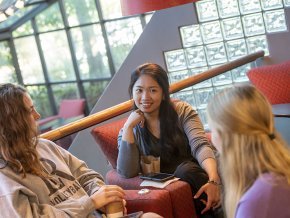 Three older students in conversation at Joe's Coffee