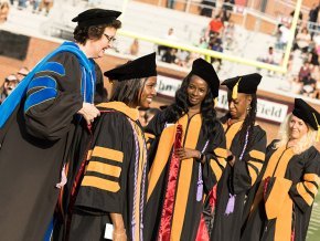 Kerry Thompson places academic hoods on DNP graduates at 2024 commencement