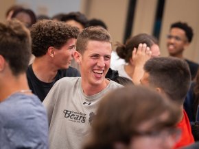 Isaac Riggs laughs with friends in the midst of a crowd at Final Flip