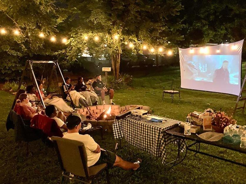 International students enjoying a cookout and movie under the stars.