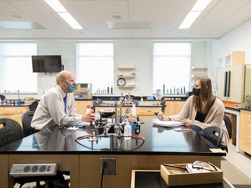 Dr. Daniel Grimm talks with a student.