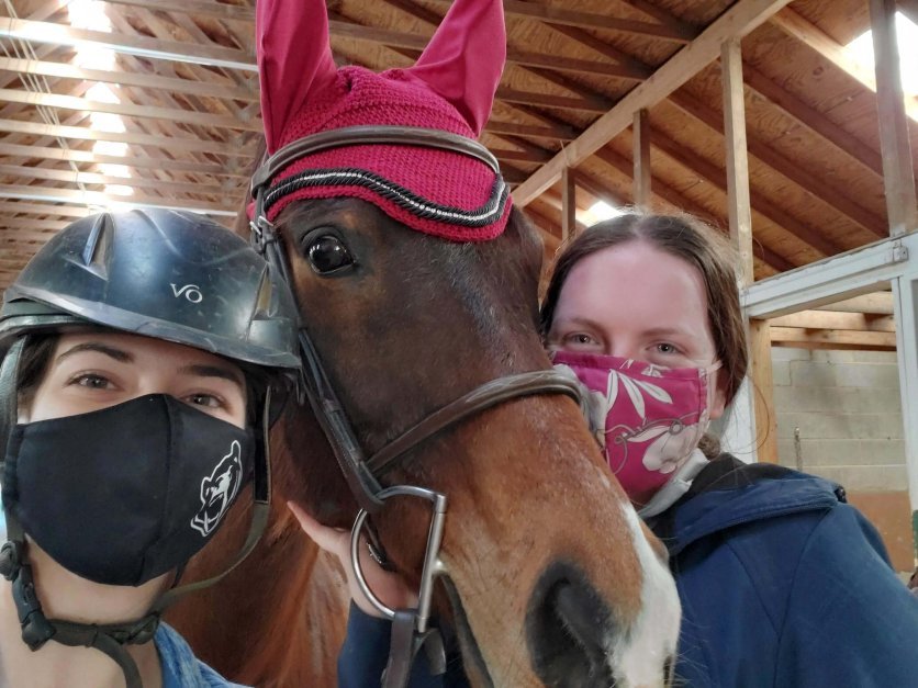 Jillian Petersen and a riding club teammate with a horse.