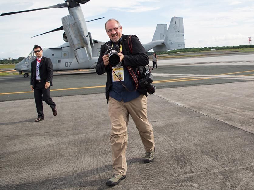 LR alumni on an airport runway with a secret service agent.