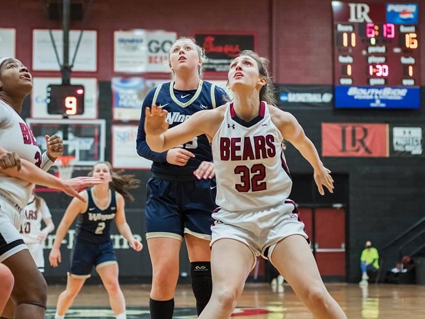 Olivia Nunn battling for a rebound on the LR women's basketball team.