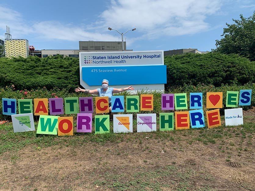 LR nurse alumna Milly Treu in front of a hospital sign.