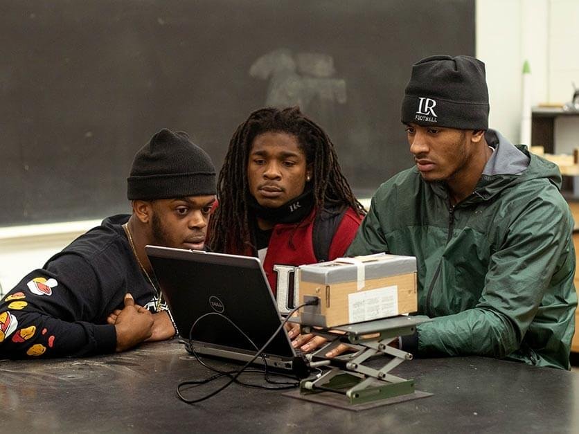 LR football players working in the engineering lab