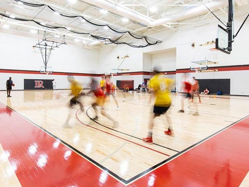 Students playing basketball in the intramural gym