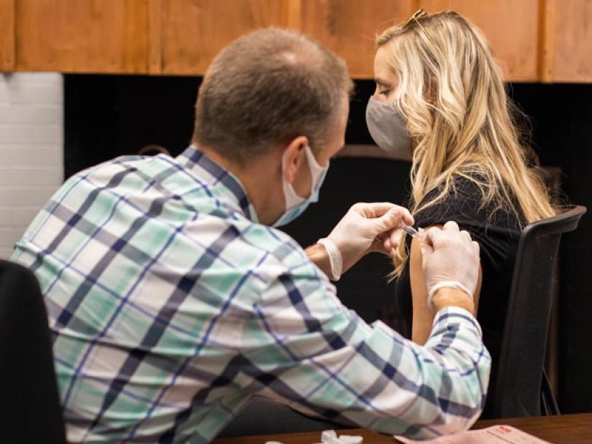 A person gets a flu shot in their arm