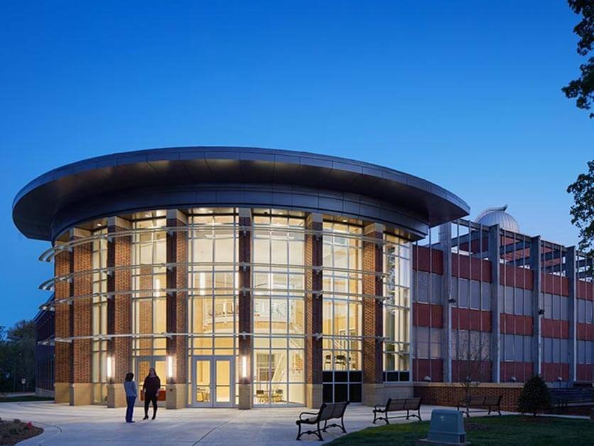 The exterior of George Hall lit up at night