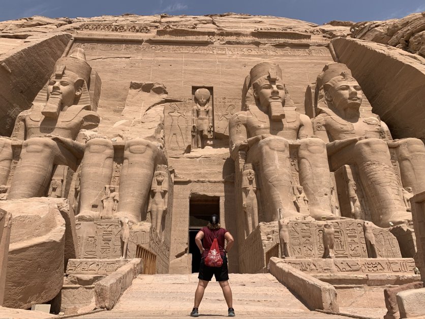 Chrissy Elliot stands with her back to the camera looking at the Great Pyramid of Giza in Egypt.