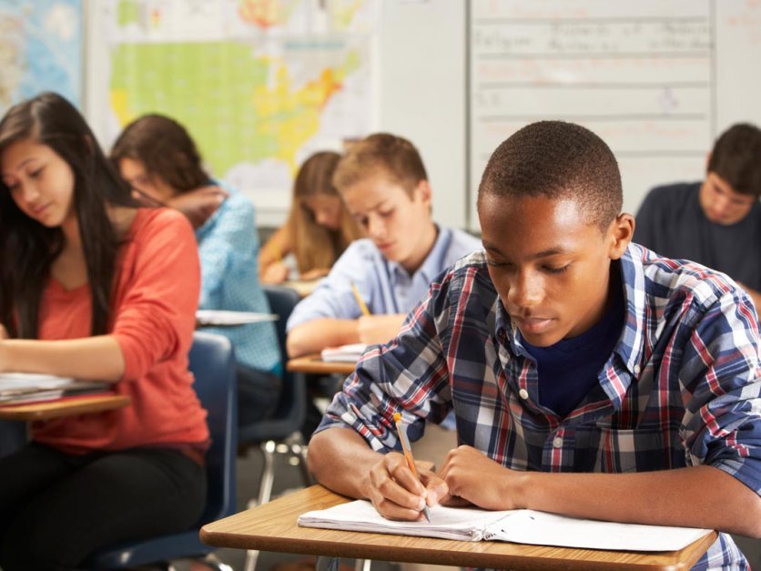 High school students working at desks in classroom