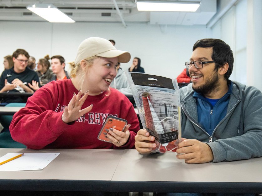 Two students talking at table during Rocket Team meeting