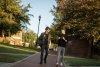 Two male students walk outside