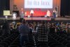 A group of children watch a play on a stage