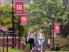 Students walking on campus with LR banners on light poles