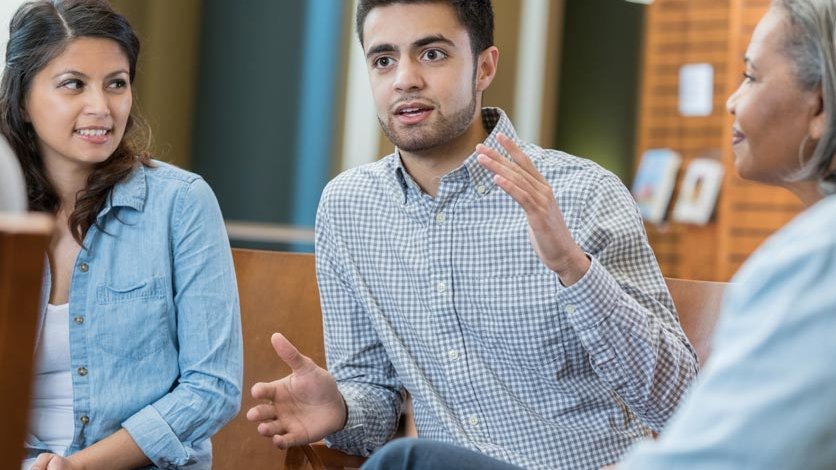 Three people talking during a group counseling session