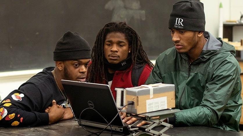 LR football players working in the engineering lab