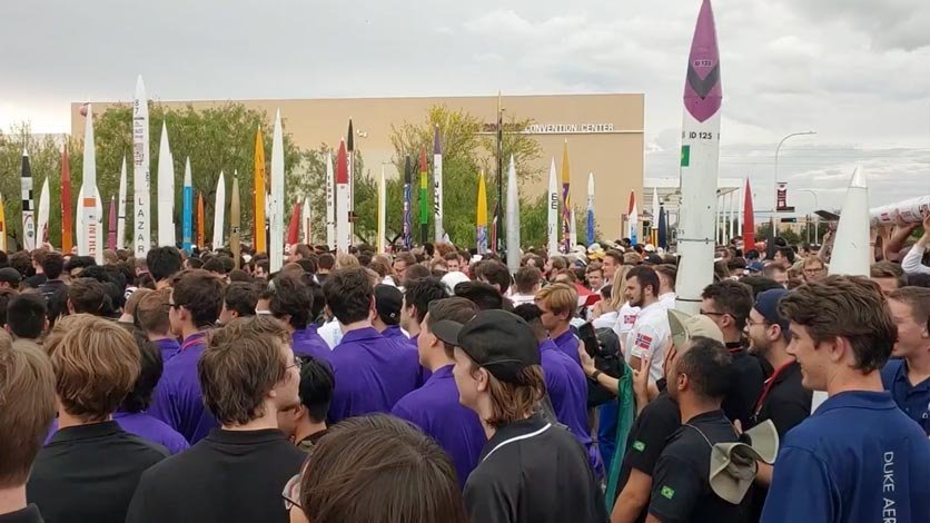 Students gather outside with their rockets during the Spaceport America 2022 competition